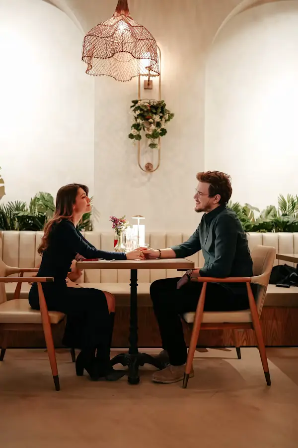 Couple having a relaxed conversation during a first date at a cafe